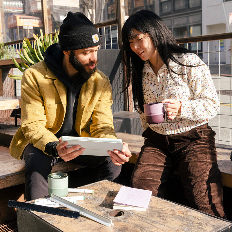 12oz-rise-mug-q4 12oz_rise_coffee_mug_dusty_orchid_couple_city_patio_square.jpg