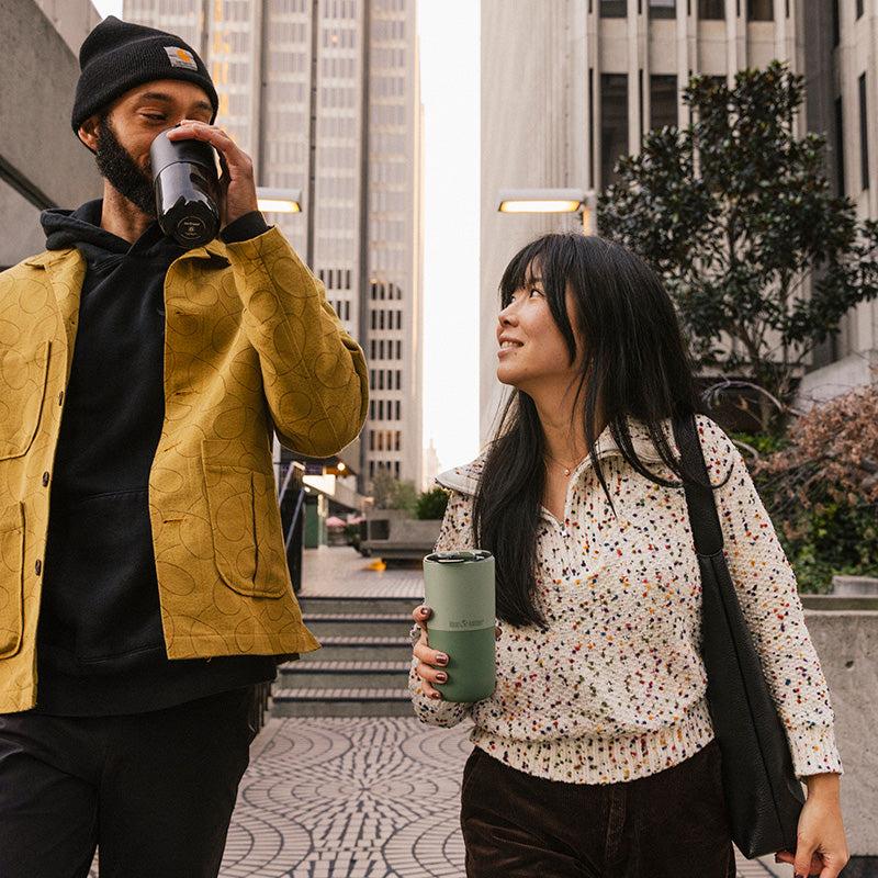 16oz-rise-tumbler-e7 16oz_rise_tumbler_black_iceberg_couple_drink_city_street_square.jpg