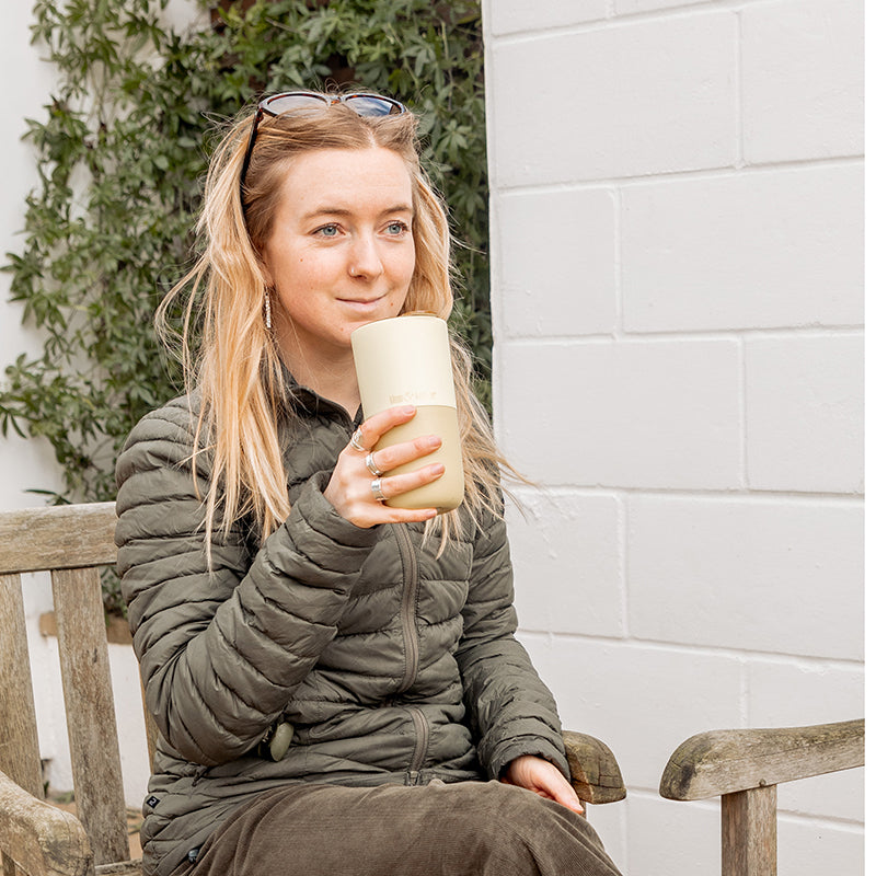 16oz-rise-tumbler-e7 16oz_rise_tumbler_wax_yellow_woman_seat_outside_square.jpg