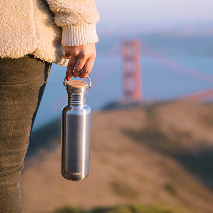 27oz-reflect-with-bamboo-cap-f9 K27SSLRF-BS-BAMBOO_reflect_bottle_bridge_lifestyle.jpg